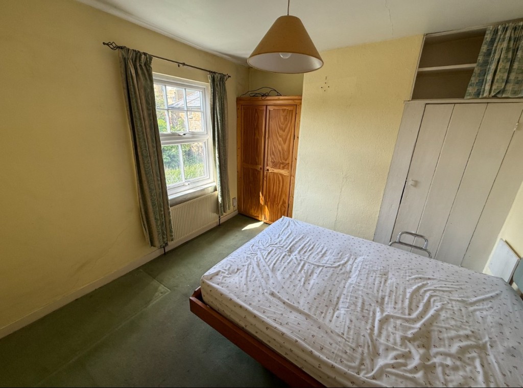 Lot: 76 - TWO-BEDROOM MID-TERRACE HOUSE FOR IMPROVEMENT - Bedroom to front of property with window